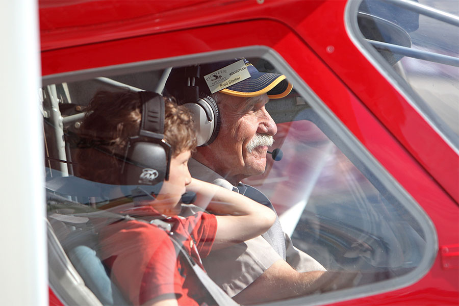 Fred Stadler giving young eagle flight at pioneer airport